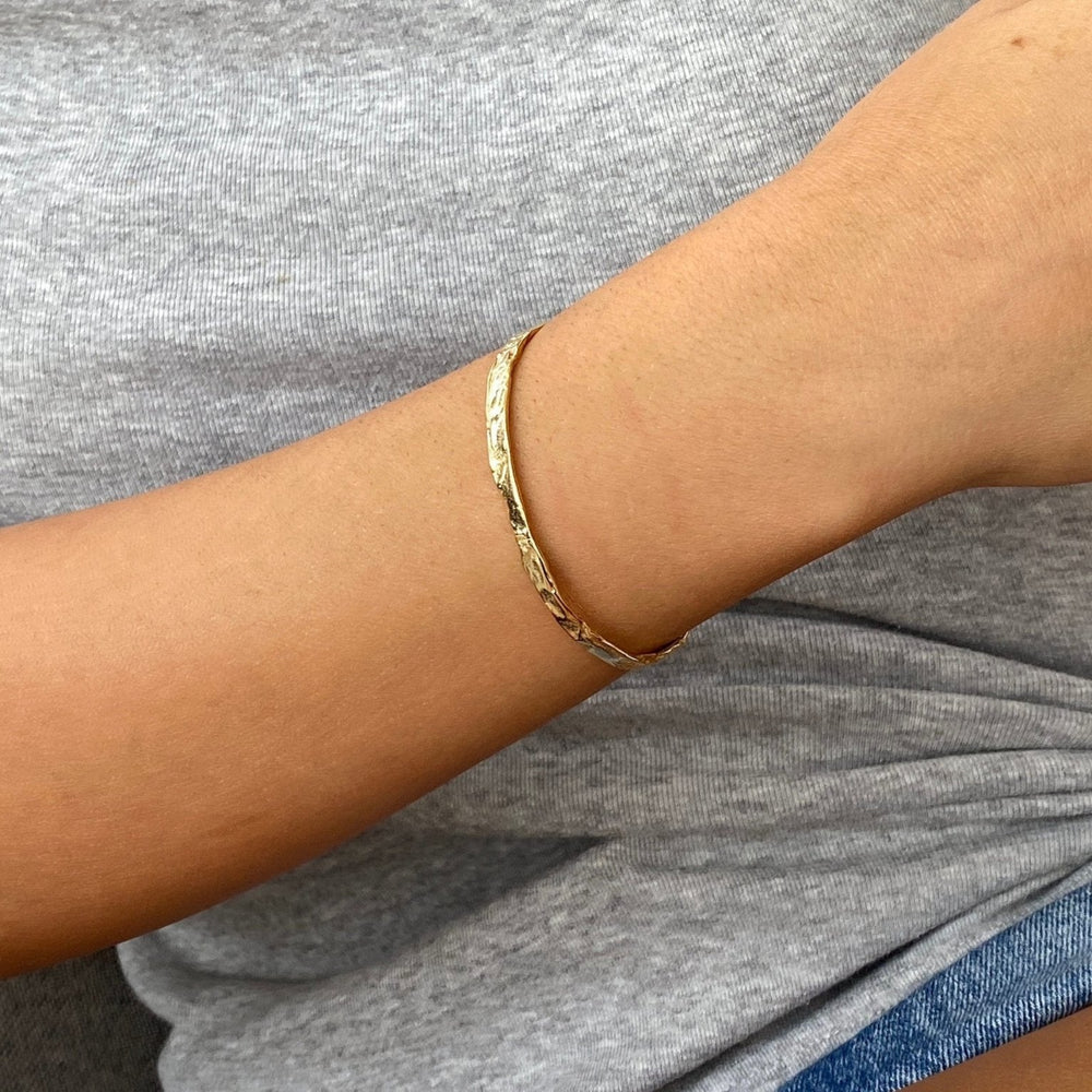 Hammered bangle on arm of young woman from Alicia's Diary