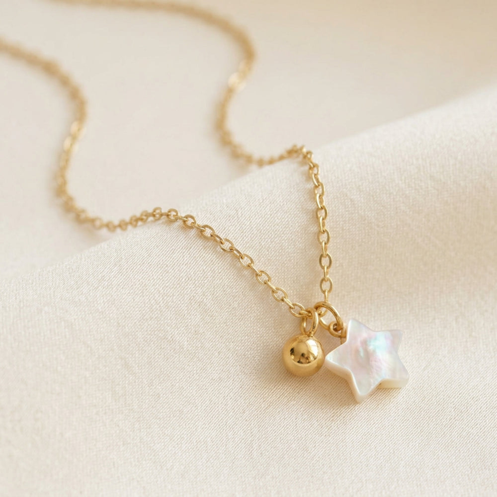Necklace with double pendant made of genuine mother-of-pearl. Gold necklace with mother-of-pearl star and gold ball on a gold-plated 925 sterling silver chain from Alicia's Diary