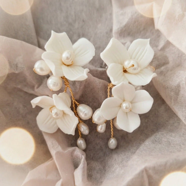 Sophie bridal earrings with white blossoms and pearls on delicate tissue paper