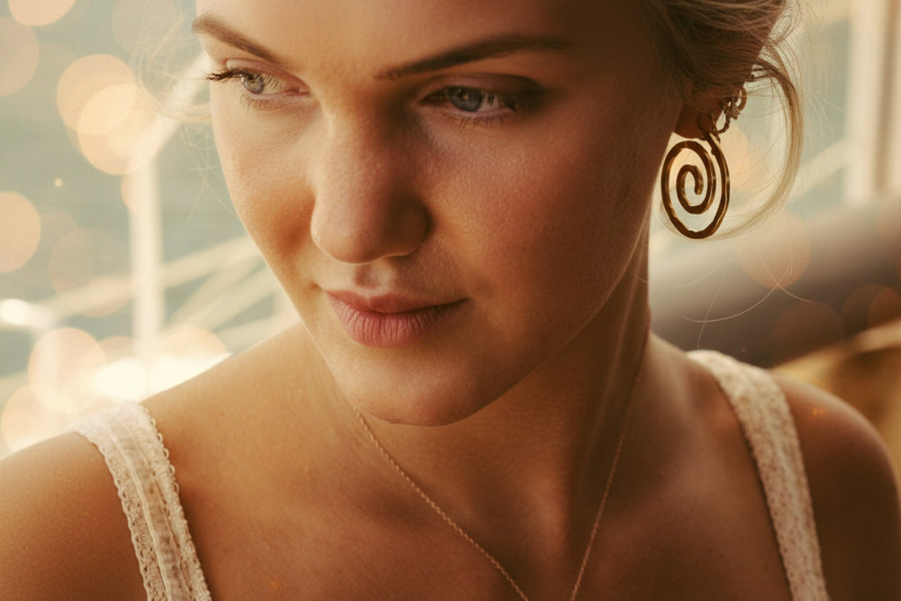 Waterproof gold stainless steel earrings with a hammered texture on a young woman with a gold necklace from Alicia's Diary