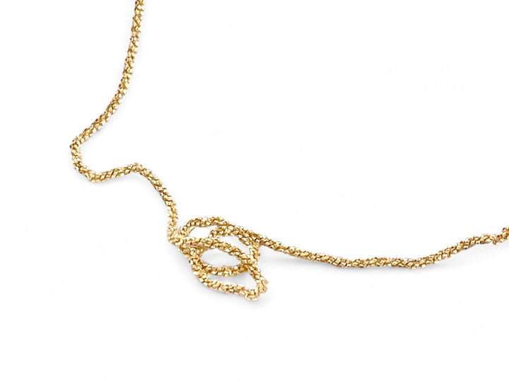 Gold necklace against a white background