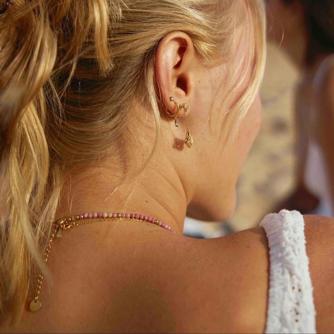 Colorful beaded necklace, gemstone necklace, waterproof beach jewelry inspiration in a stack of gold, white beach dress