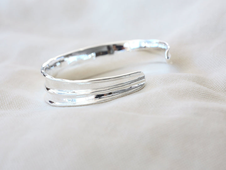 Wide silver bangle with handmade finish - Alicia&